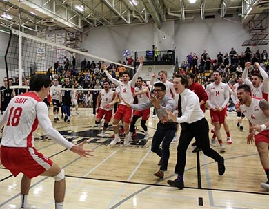 SAIT's Juan Becerra is mobbed by teammates after being named Player of the Game in the ACAC Men's Volleyball Championship Final Saturday night against the Keyano College Huskies